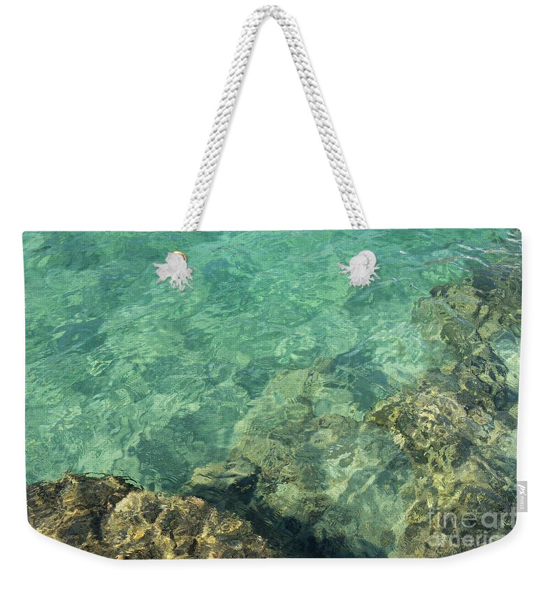 Turquoise Weekender Tote Bag featuring the photograph Turquoise blue water on the Mediterranean coast by Adriana Mueller