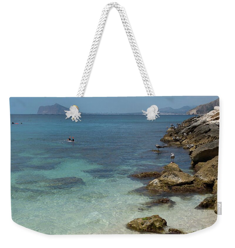 Mediterranean Weekender Tote Bag featuring the photograph Turquoise blue sea water and rocks in Calpe 3 by Adriana Mueller