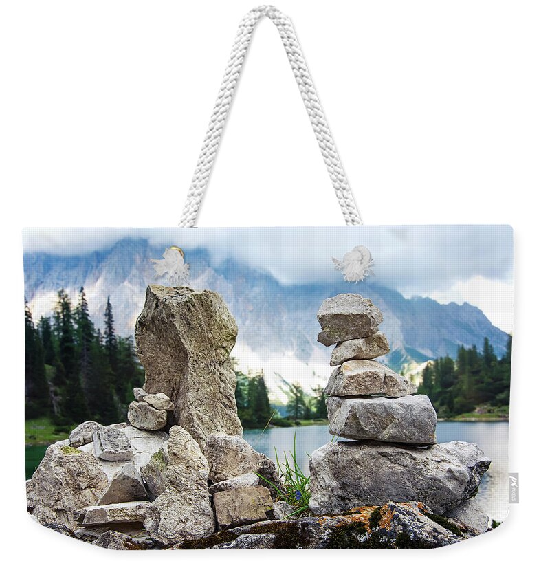 Two Weekender Tote Bag featuring the photograph Two stone towers as route markers. by Bernhard Schaffer