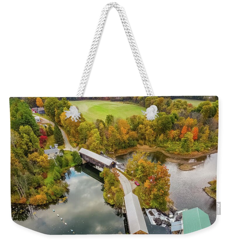 Hartland Vermont Weekender Tote Bag featuring the photograph Vertical Vermont autumn colors over the Willard Twin Bridges by Jeff Folger