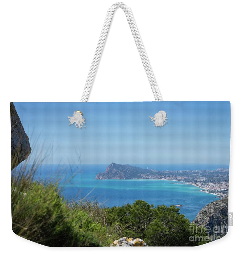 Spain Weekender Tote Bag featuring the photograph View of the coast and the Mediterranean sea in Benidorm by Adriana Mueller