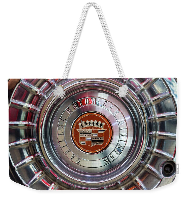 Cadillac Weekender Tote Bag featuring the photograph Vintage Cadillac De Ville Convertible 1967 wheel with emblem by Viktor Wallon-Hars