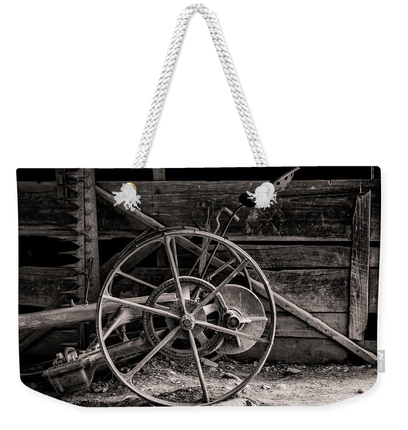 Wheel Weekender Tote Bag featuring the photograph Vintage Farm Machine by Ginger Stein