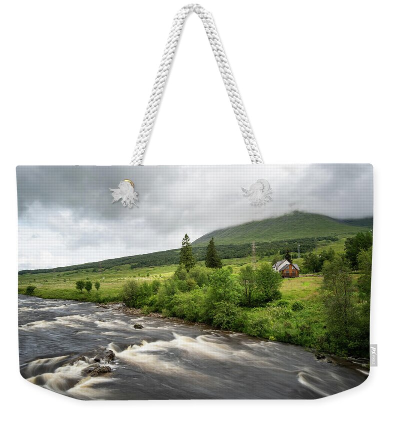 Bridge Of Orchy Weekender Tote Bag featuring the photograph Water flowing in the river. River Orchy Highlands of Scotland by Michalakis Ppalis