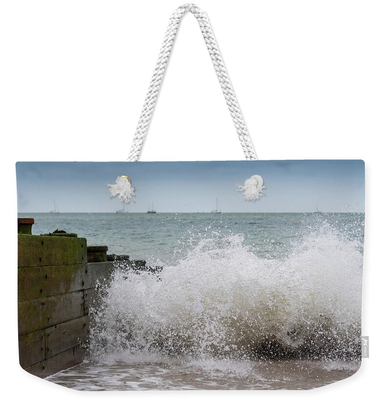 Eastbourne Weekender Tote Bag featuring the photograph Wave splash by Andrew Lalchan