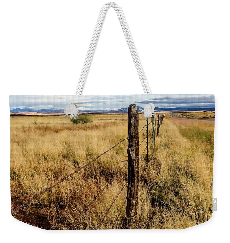 Oldwest Weekender Tote Bag featuring the photograph West Texas Fenceline by Pam Rendall