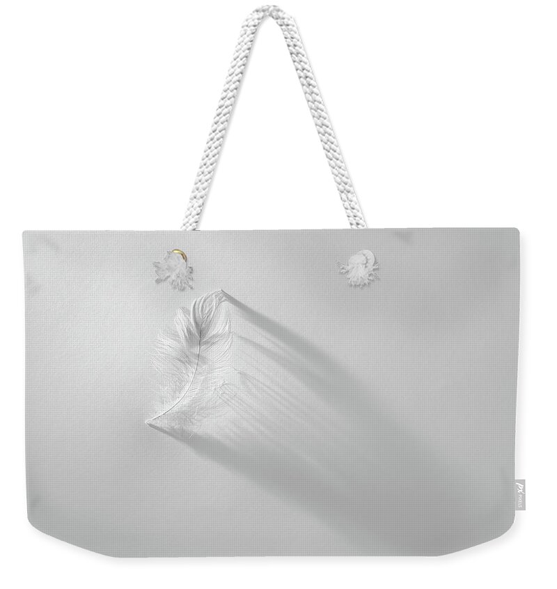 Feather Weekender Tote Bag featuring the photograph White Feather by Scott Norris