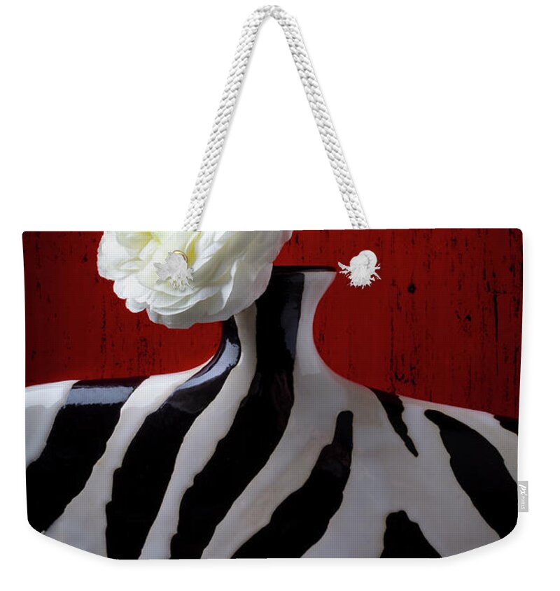  Weekender Tote Bag featuring the photograph White Ranunculus In Vase Against Red wall by Garry Gay