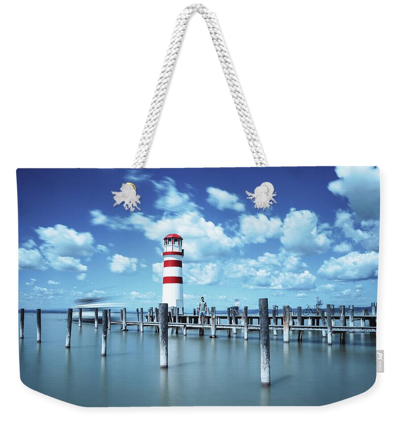 Destinations Weekender Tote Bag featuring the photograph White-red lighthouse in Podersdorf am See by Vaclav Sonnek