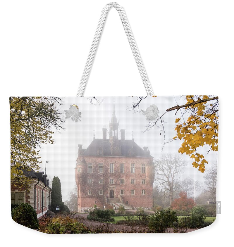 Wik Castle Weekender Tote Bag featuring the photograph Wik Castle a foggy autumn morning by Torbjorn Swenelius