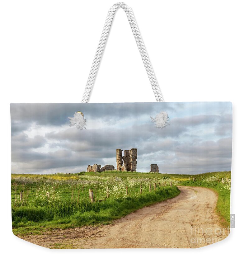 British Weekender Tote Bag featuring the photograph Winding road leading to a chirch ruin in Norfolk by Simon Bratt