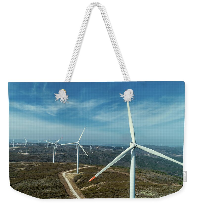 Wind Weekender Tote Bag featuring the photograph Windmills or wind turbine on wind farm by Mikhail Kokhanchikov