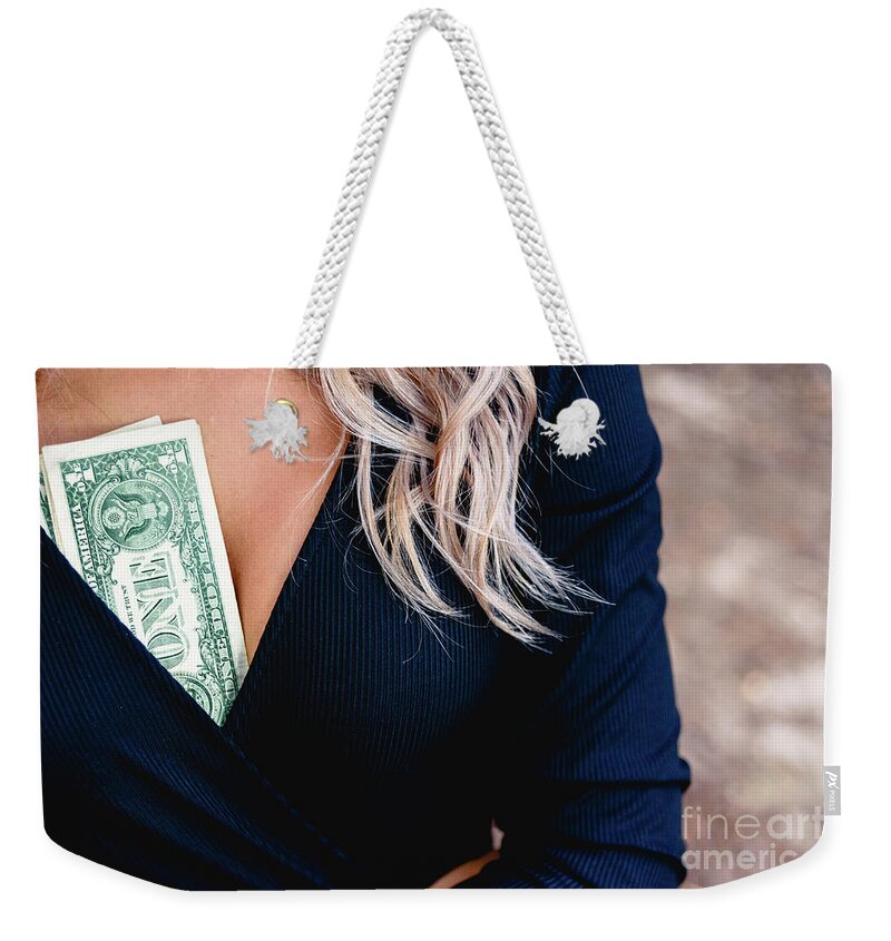 Abuse Weekender Tote Bag featuring the photograph Woman with some dollar bills inside her cleavage, concept of mal by Joaquin Corbalan