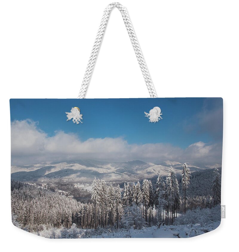 Spruce Weekender Tote Bag featuring the photograph Wooded land covered with snow by Vaclav Sonnek