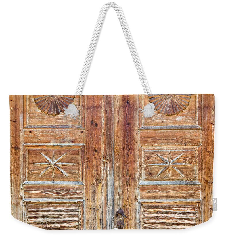 Brown Weekender Tote Bag featuring the photograph Patterns on wooden door by Viktor Wallon-Hars
