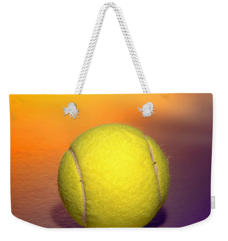 Background Weekender Tote Bag featuring the photograph Yellow Tennis Sport Ball over Purple Background by Olivier Le Queinec