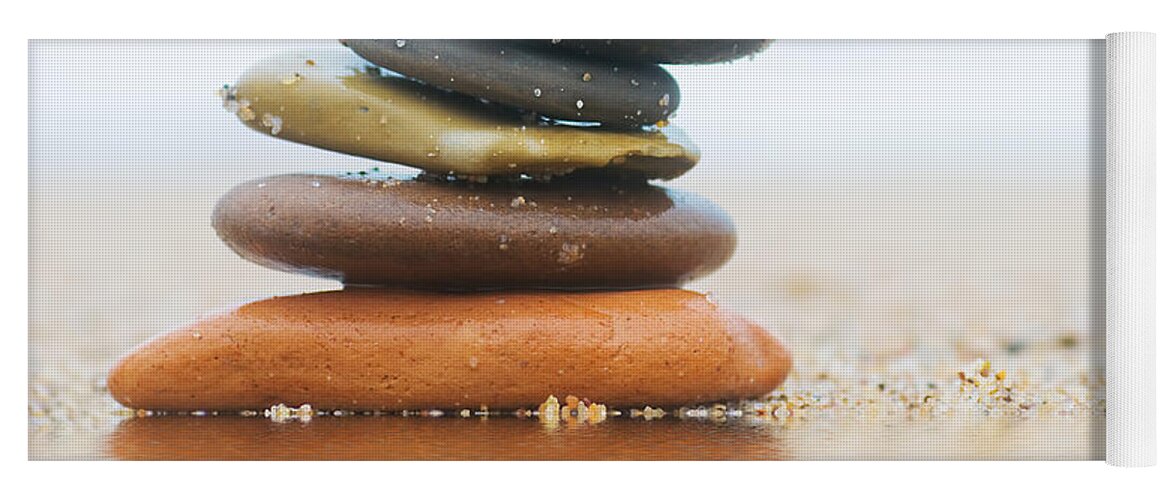 Stone Yoga Mat featuring the photograph Stack of beach stones on sand #2 by Michal Bednarek