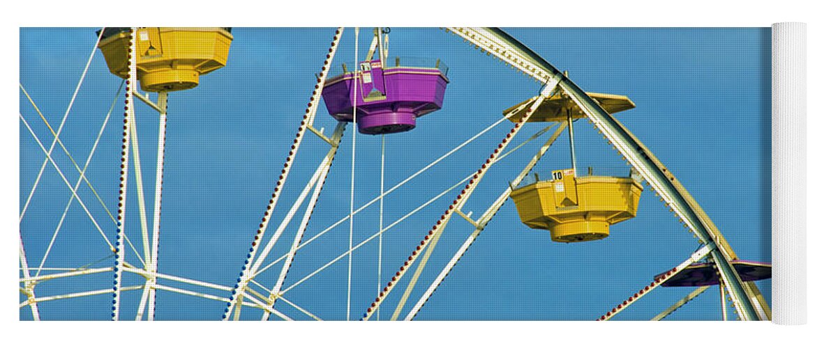 Ferris Wheel Yoga Mat featuring the photograph Ferris Wheel rotating upright wheel with passenger cars by David Zanzinger