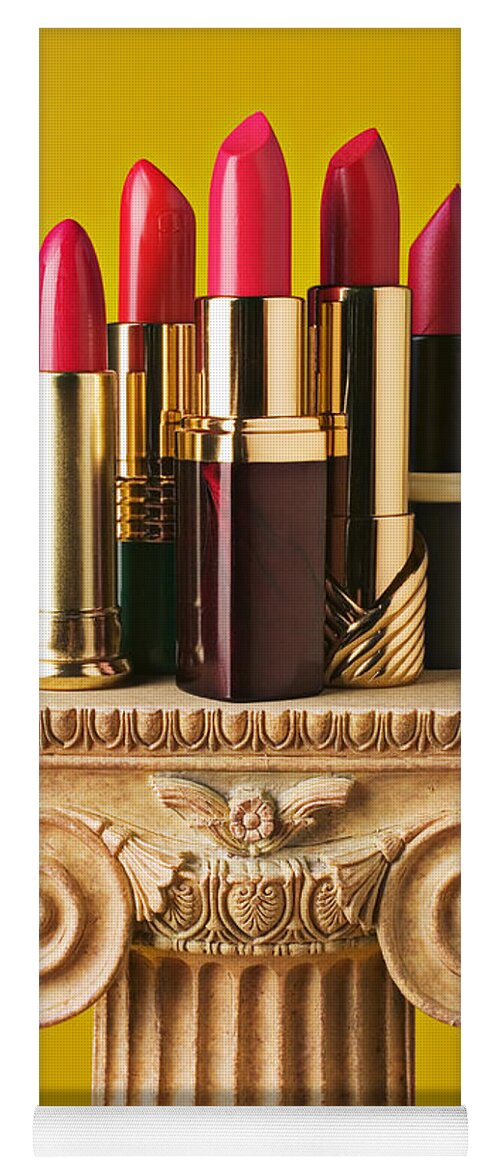 Cosmetics Yoga Mat featuring the photograph Five red lipstick tubes on pedestal by Garry Gay
