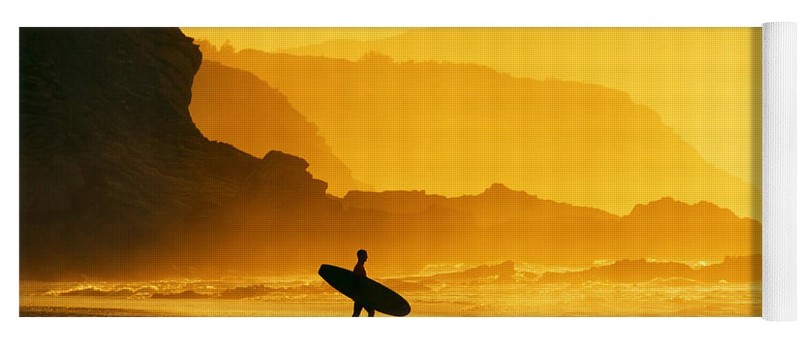 Surfer Yoga Mat featuring the photograph Surfer Entering Water At Misty Sunset by Mikel Martinez de Osaba
