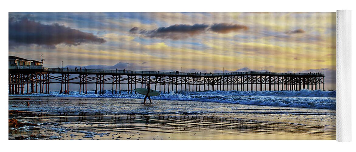 Pacific Beach Yoga Mat featuring the photograph A surfer heads home under a cloudy sunset at Crystal Pier by Sam Antonio