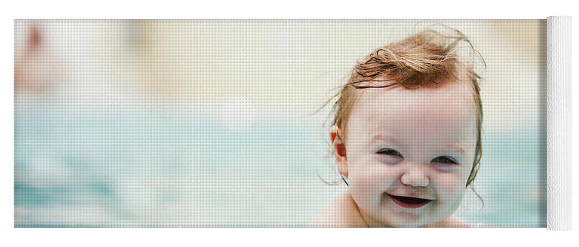 Girl Yoga Mat featuring the photograph Baby girl smiling and swimming in water. by Michal Bednarek