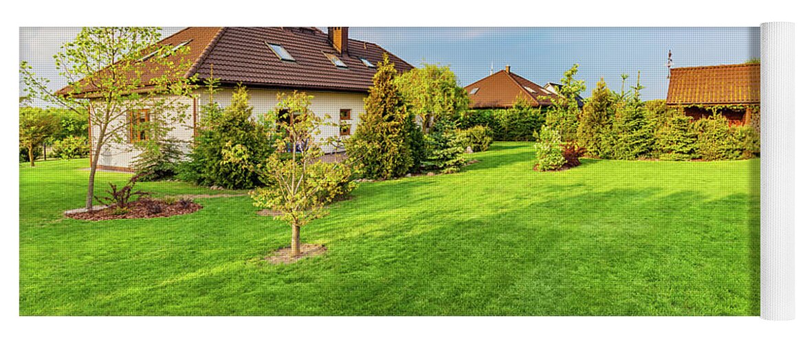 Garden Yoga Mat featuring the photograph Backyard of a family house. Spacious landscaped garden with green mown grass by Michal Bednarek