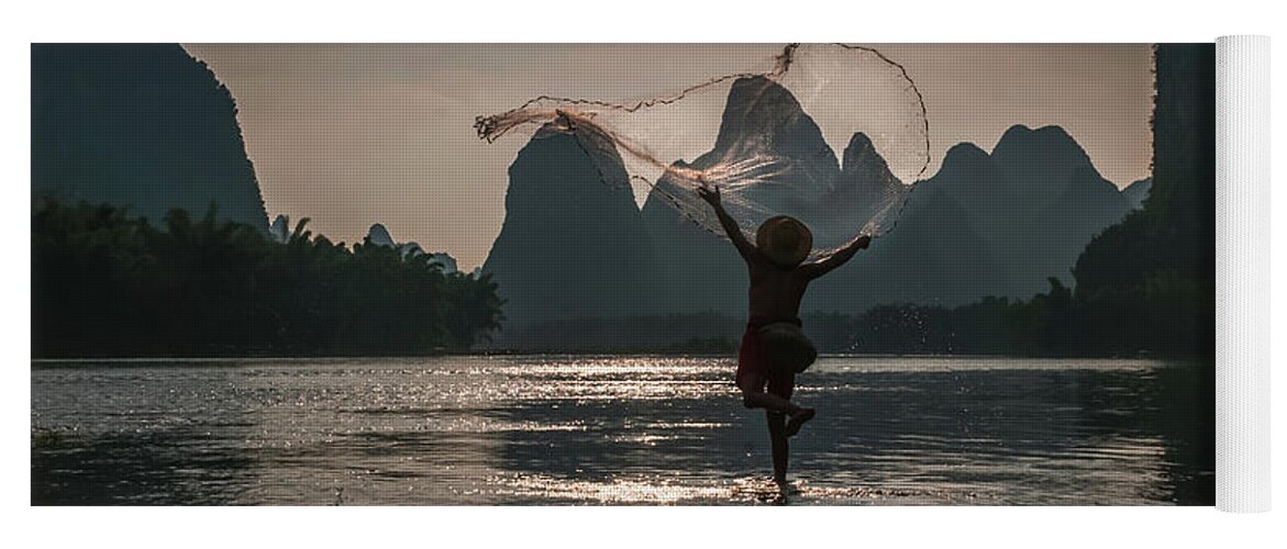 Asia Yoga Mat featuring the photograph Fisherman casting a net. by Usha Peddamatham
