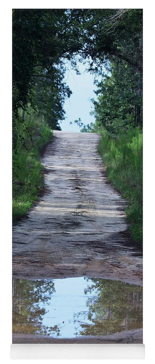 Forest Road And Puddle Yoga Mat featuring the photograph Forest Road and Puddle by Warren Thompson