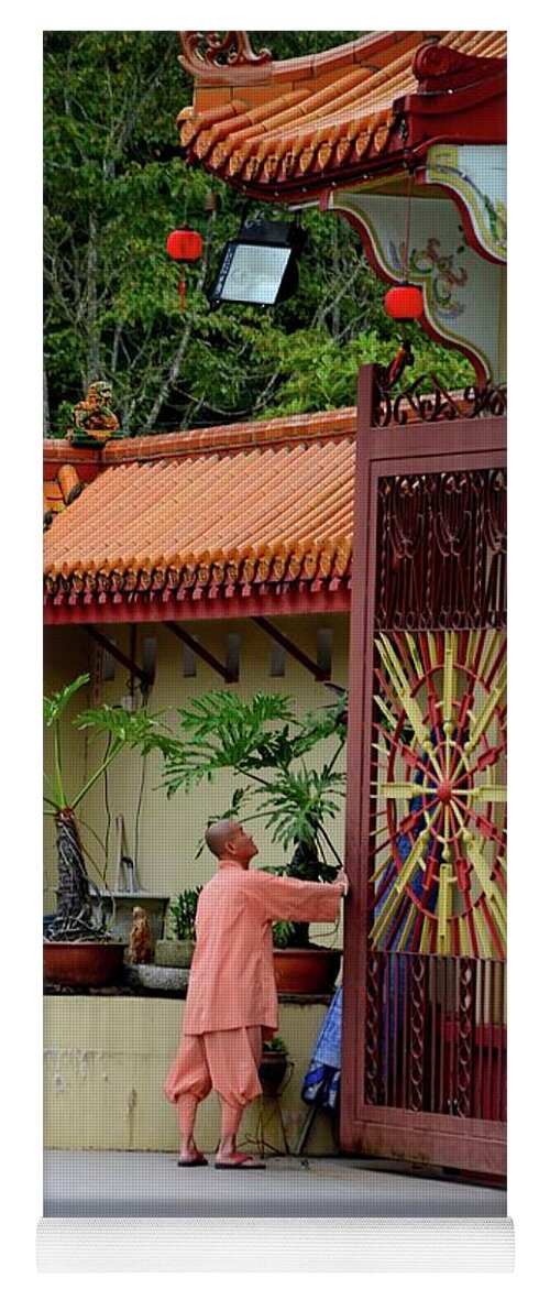 Temple Yoga Mat featuring the photograph Monk opens main gate and readies Sam Poh Chinese Buddhist temple Cameron Highlands Malaysia by Imran Ahmed