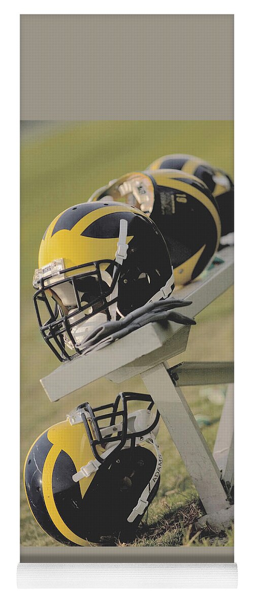 Wolverine Yoga Mat featuring the photograph Wolverine Helmets on a Football Bench by Michigan Helmet