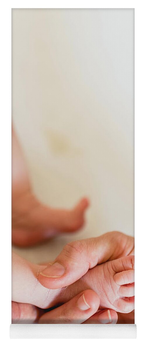 Adult Yoga Mat featuring the photograph Mommy grabbing the little feet of her newborn daughter. #1 by Joaquin Corbalan