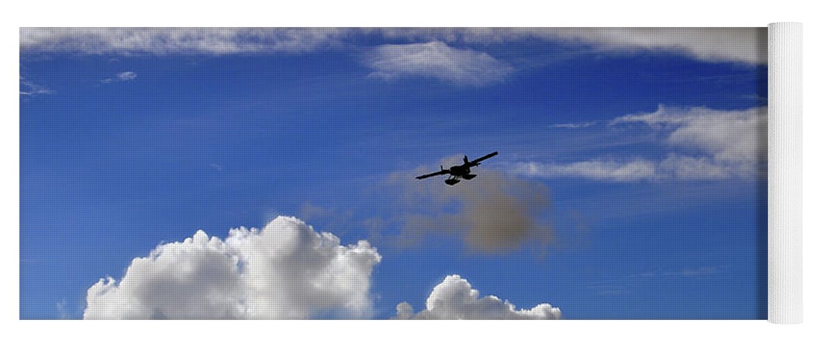 A Seaplane Is Silhouetted Against Blue Sky And White Puffy Clouds. Yoga Mat featuring the photograph Seaplane Skyline by Climate Change VI - Sales