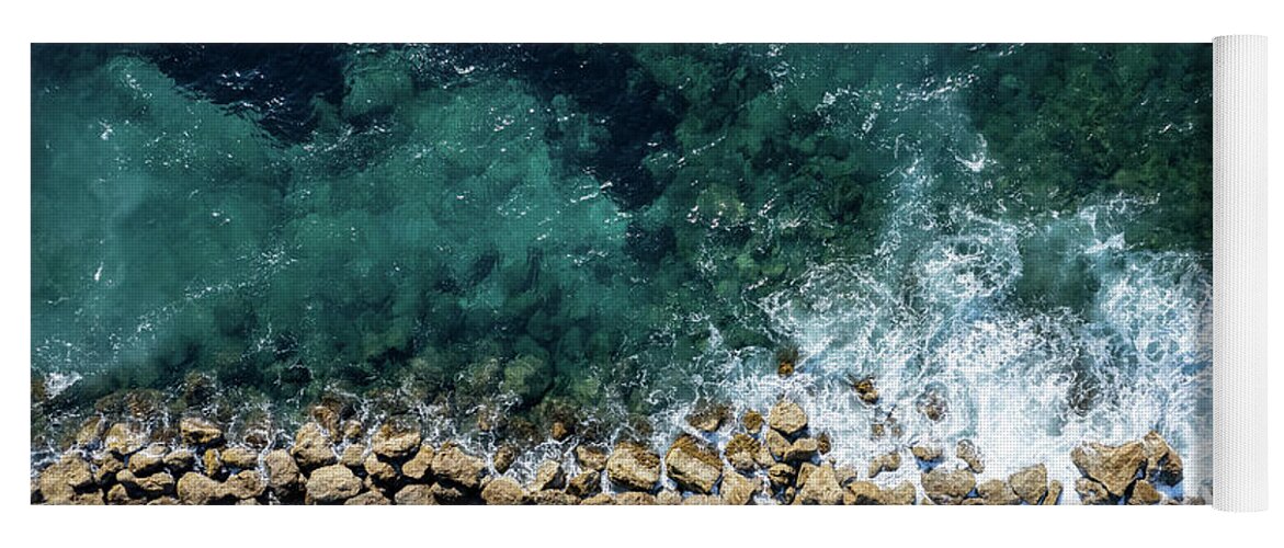 Seascape Yoga Mat featuring the photograph Aerial view from flying drone of crystal blue ocean water and sea wall. by Michalakis Ppalis