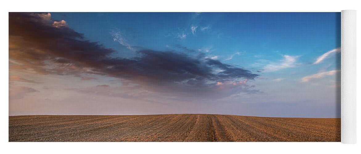 Nightfall Yoga Mat featuring the photograph Agricultural meadow field and cloudy sky during sunset. by Michalakis Ppalis