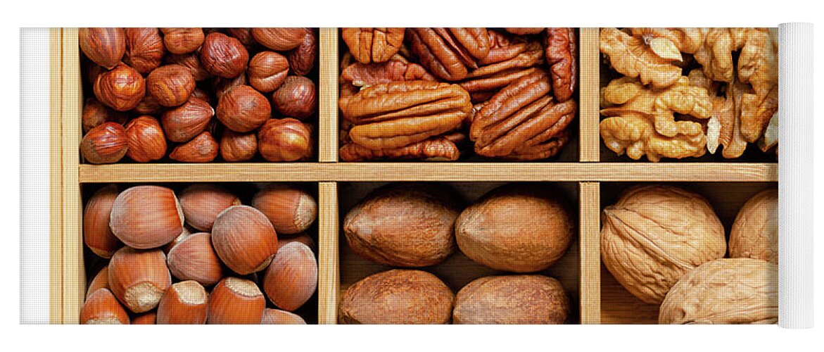 Hazelnuts, Pecans and walnuts, shelled and in their shells, in wooden box  Yoga Mat