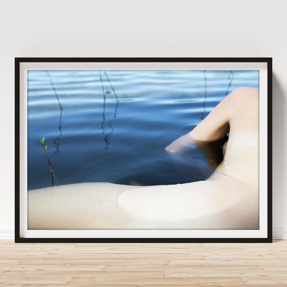 Art Print of Beautiful nude woman lying on rocks in water with sea