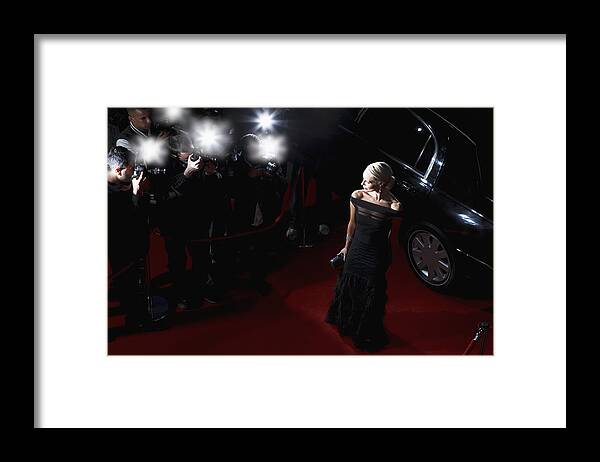 Young Men Framed Print featuring the photograph Celebrity posing for paparazzi on red carpet #1 by Tom Merton