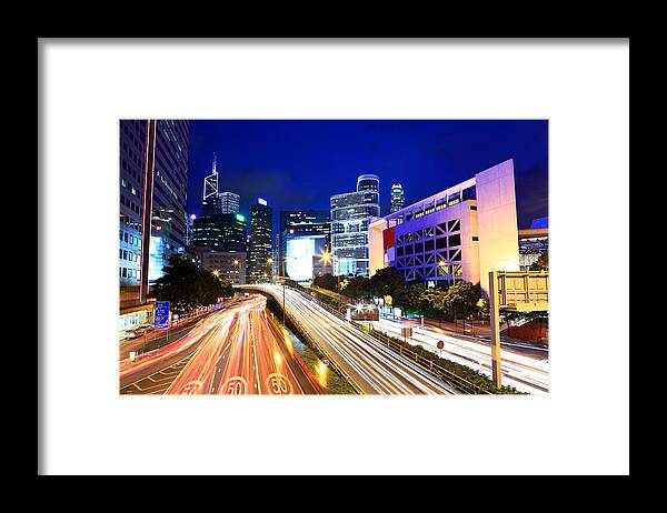 Financial Building Framed Print featuring the photograph City At Night With Traffic Trails #1 by Ngkaki