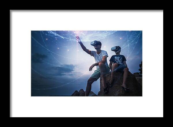 Dawn Framed Print featuring the photograph Father and son using Virtual Reality glasses sitting outside #1 by Da-kuk