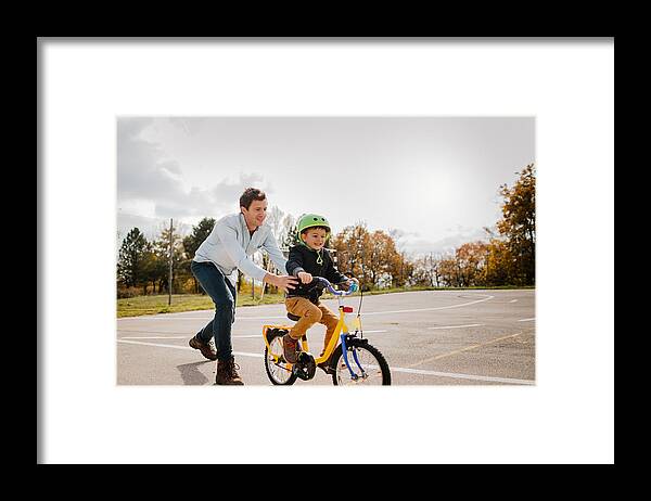 Young Men Framed Print featuring the photograph Learning to ride a bicycle #1 by AleksandarNakic