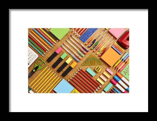 Education Framed Print featuring the photograph Office and school supplies arranged on wooden table - Knolling #1 by Neustockimages