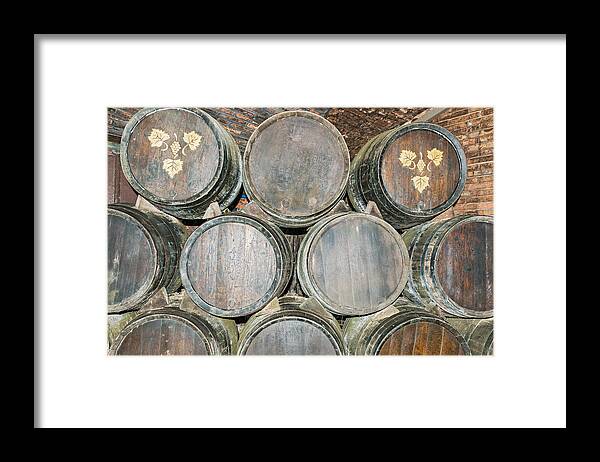 Barrel Framed Print featuring the photograph Old wine barrels in Codorniu winery in Spain #1 by Marek Poplawski