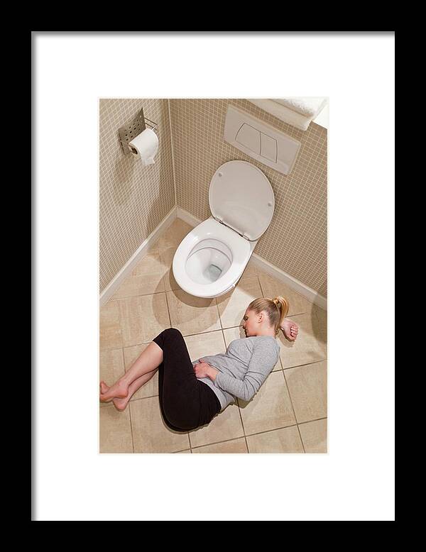 One Person Framed Print featuring the photograph Pregnant Woman Lying On Bathroom Floor #1 by Ian Hooton/science Photo Library