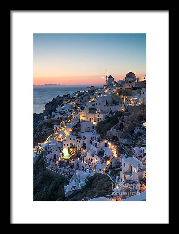 Santorini Framed Print featuring the photograph Romantic sunset over the village of Oia Greece Santorini #2 by Matteo Colombo
