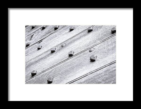 Abstract Framed Print featuring the photograph Studded wooden surface #5 by Tom Gowanlock