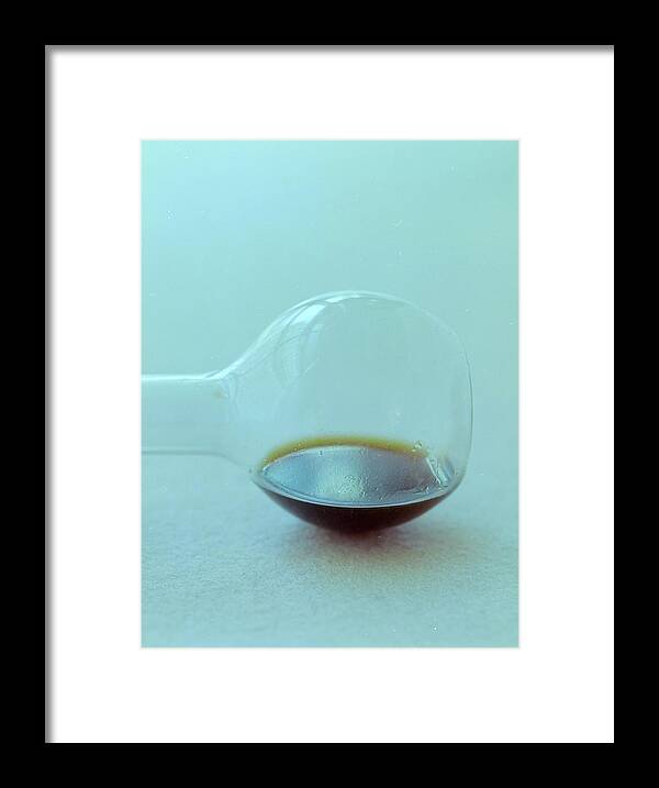 Condiment Framed Print featuring the photograph A Beaker With Vinegar by Romulo Yanes