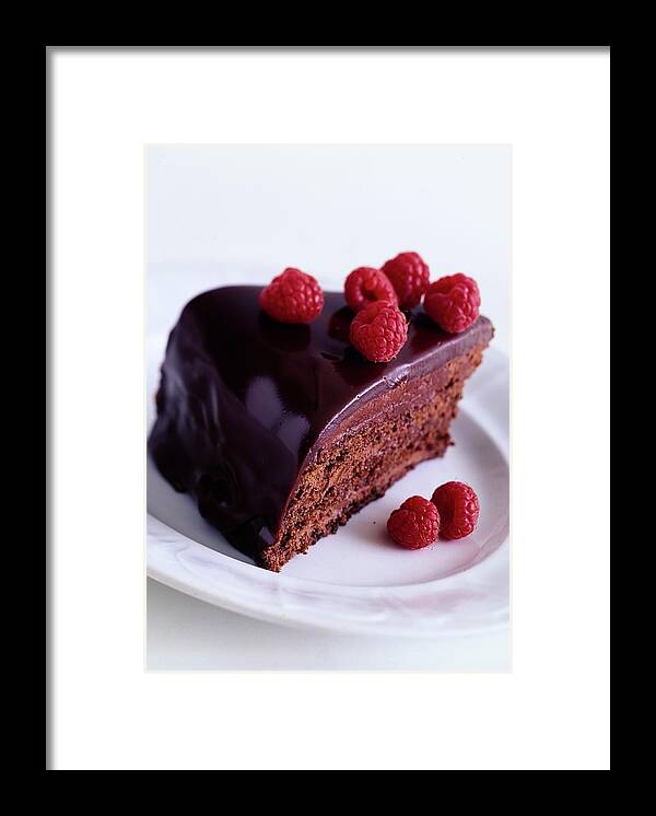 Cooking Framed Print featuring the photograph A Chocolate Pecan Cake With Raspberries On Top by Romulo Yanes