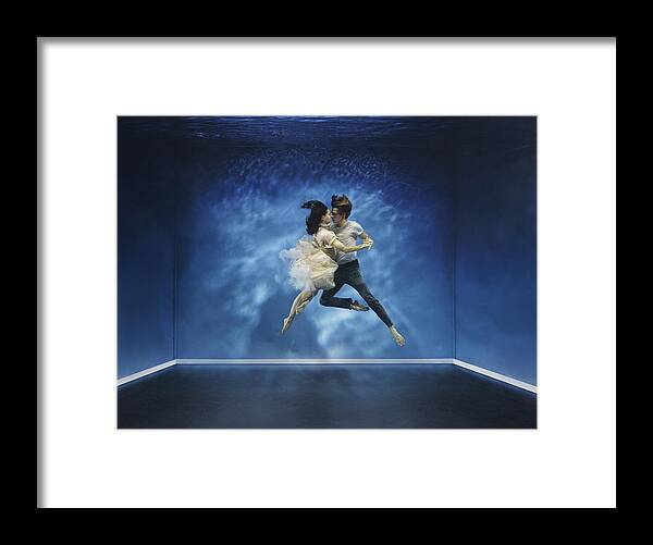 Tranquility Framed Print featuring the photograph A couple dancing under water by Henrik Sorensen