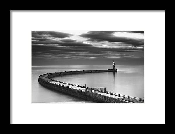 Lighthouse Framed Print featuring the photograph A Curving Pier With A Lighthouse At The by John Short